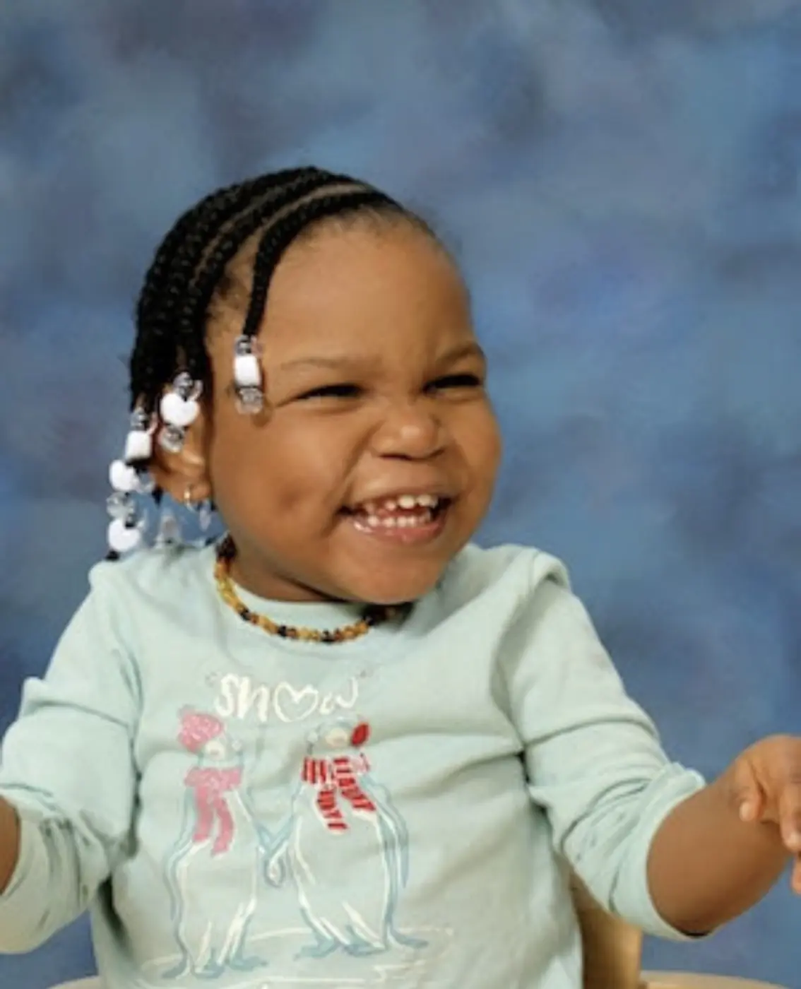 Cupcake laughing with her braids and beads